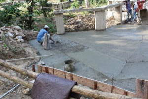 First day of pouring new concrete bridge floor with creation of drainage ditch at top of the bridge