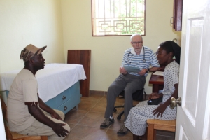 Dr. Greg VonRoenn doing a patient consultation in the clinic with his translator Reginald