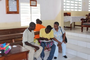 Cherlie helps with registration as we meet with patients in the Baptist church in Jérémie